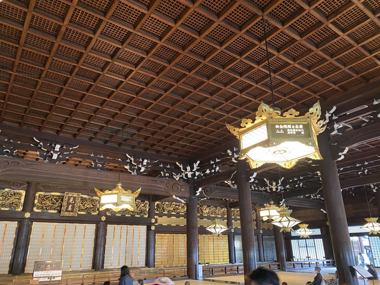 The inside of the temple showing the wooden ceiling and hanging lights