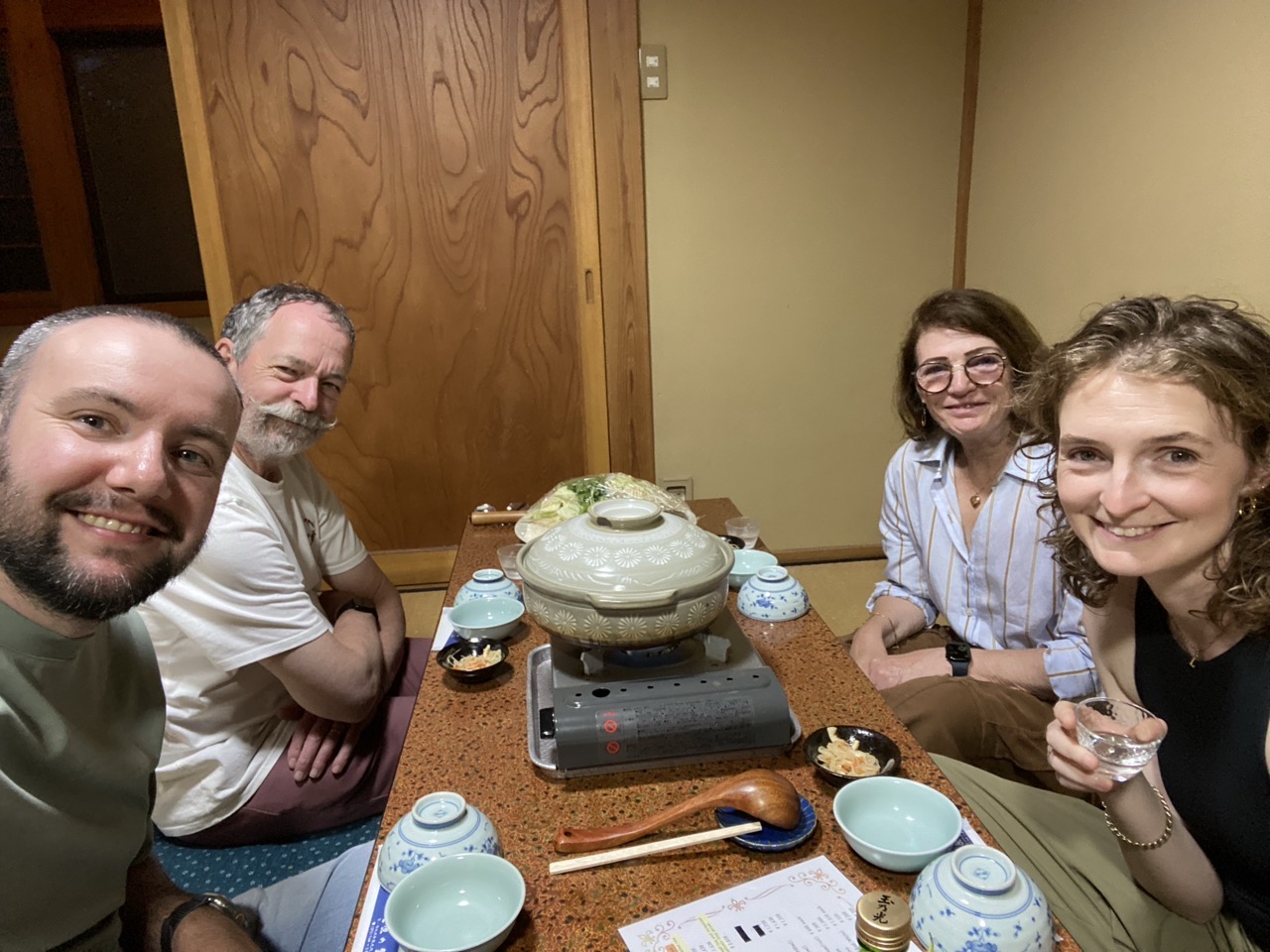 Myself, Lucy and her parents sitting round a low table having dinner which is the hot pot in the middle