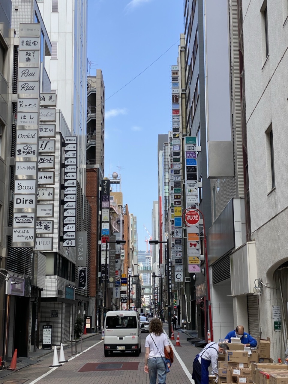 A street in Ginza with lots of signs. Lucy is, again, in the foreground.