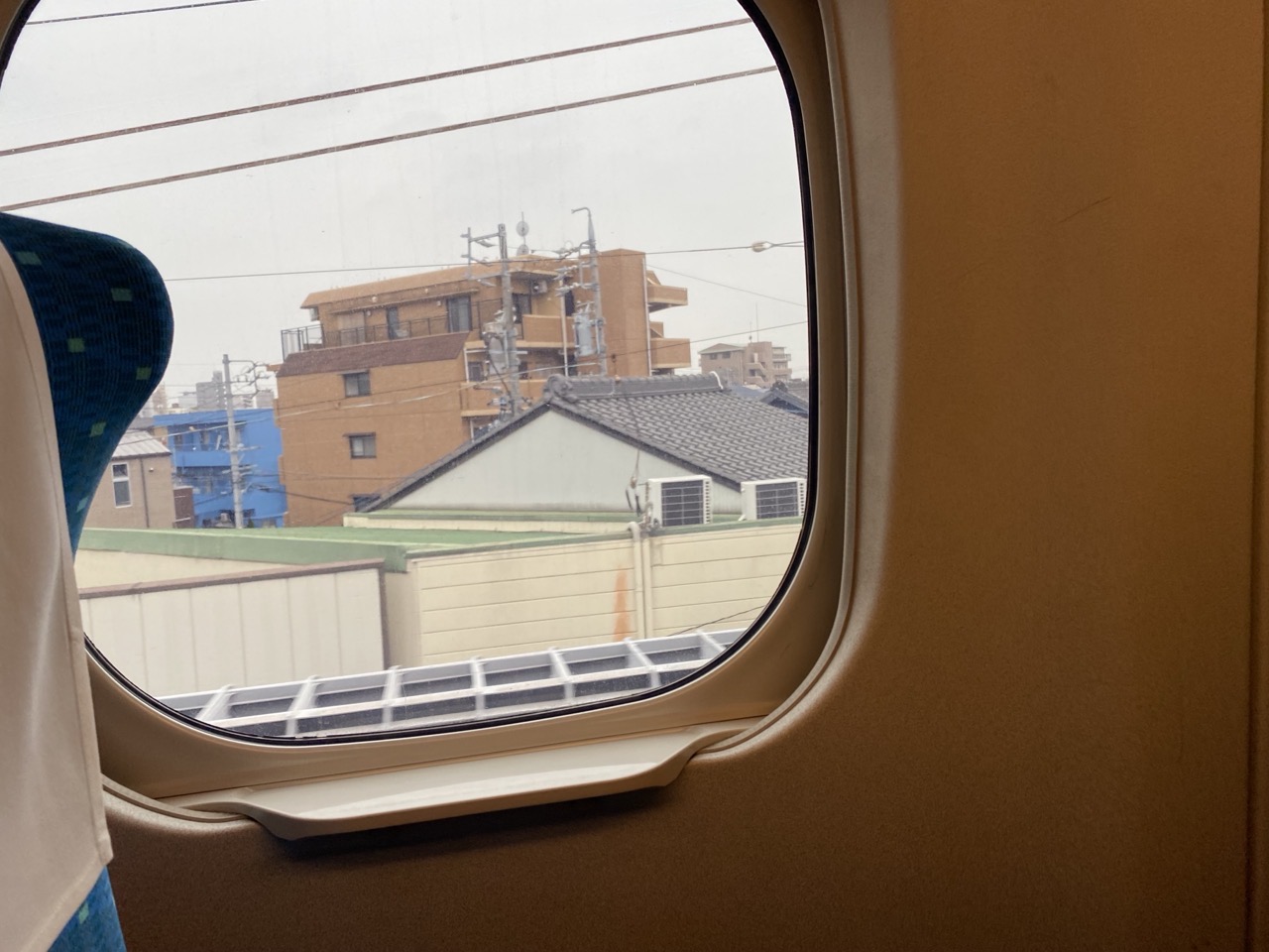The window of the Shinkansen, with an urban view