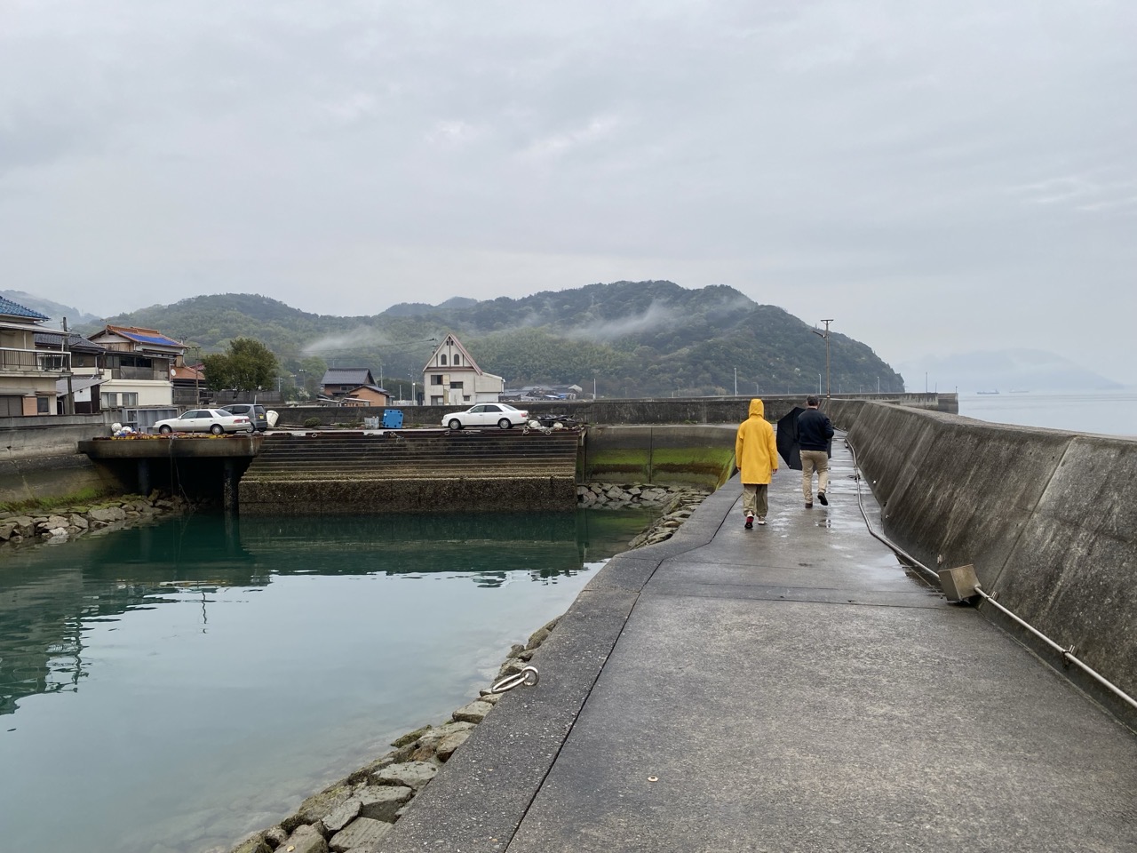 At the harbour. Lucy is in a bright yellow coat.