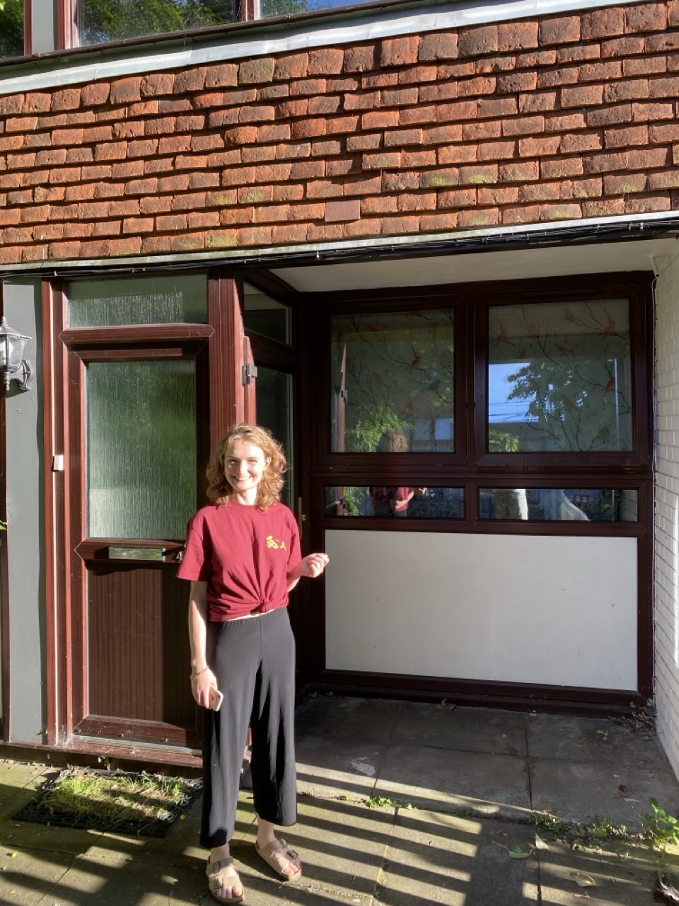 Lucy in the sunshine outside the front of our new house. It has two front doors, we don’t know why.