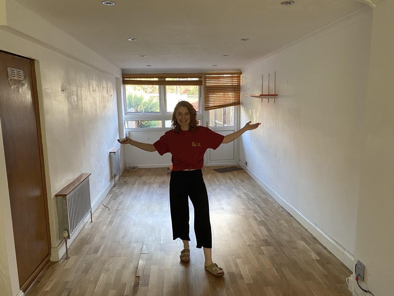 Lucy in our bare empty living room looking very pleased with herself.