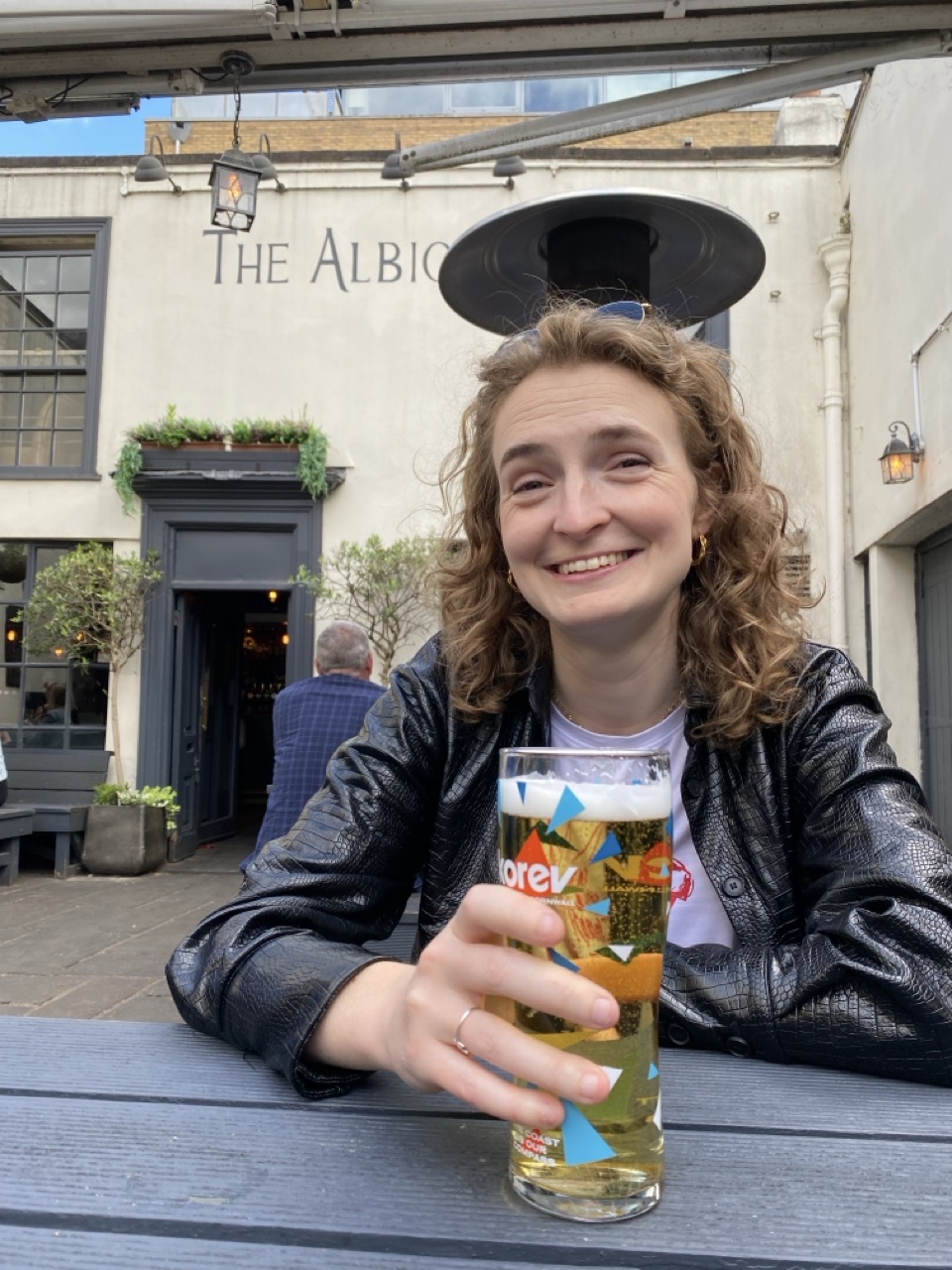 Lucy in pub with pint.
