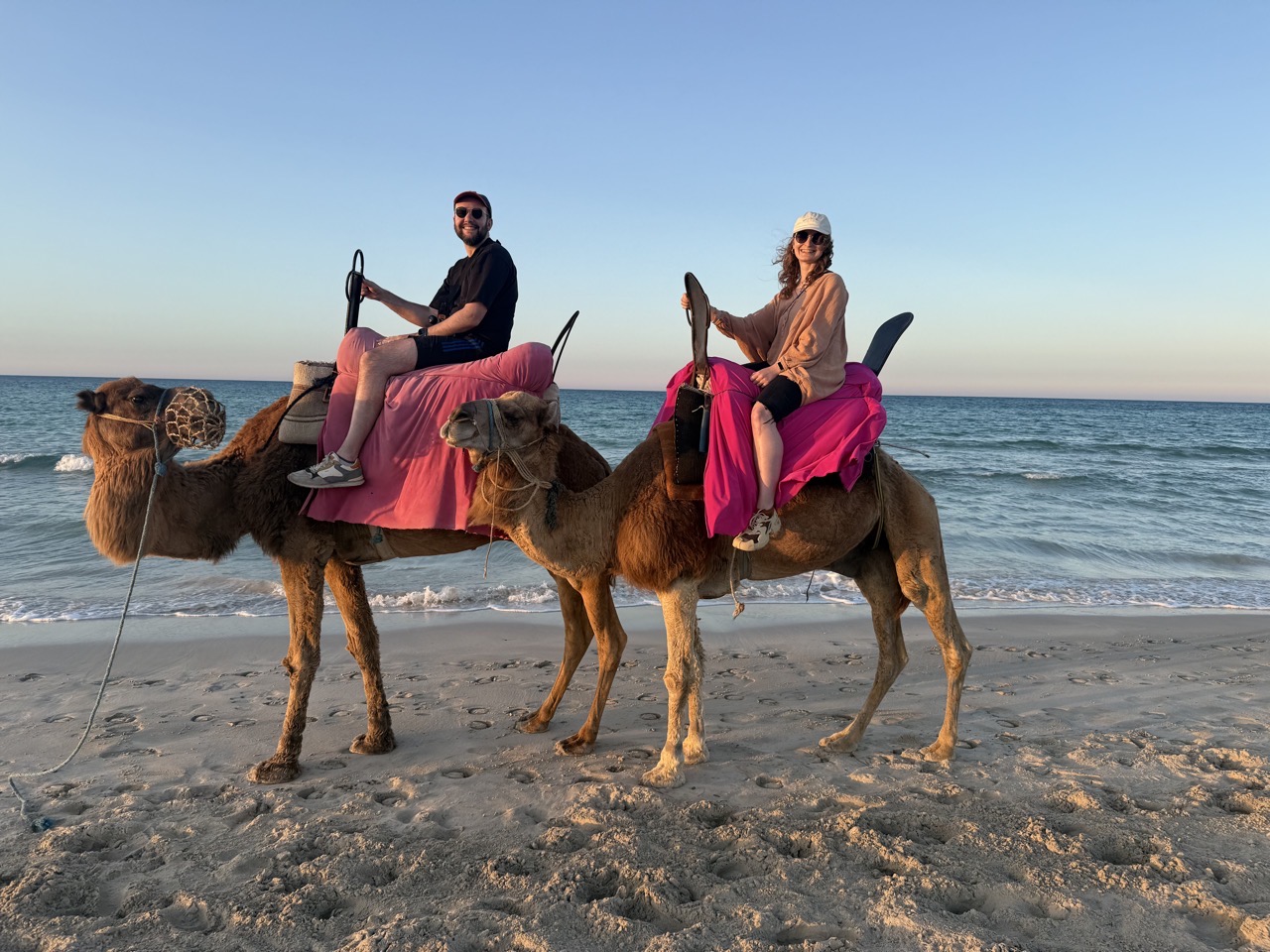 Me and Lucy on camels on a beach in Tunisia