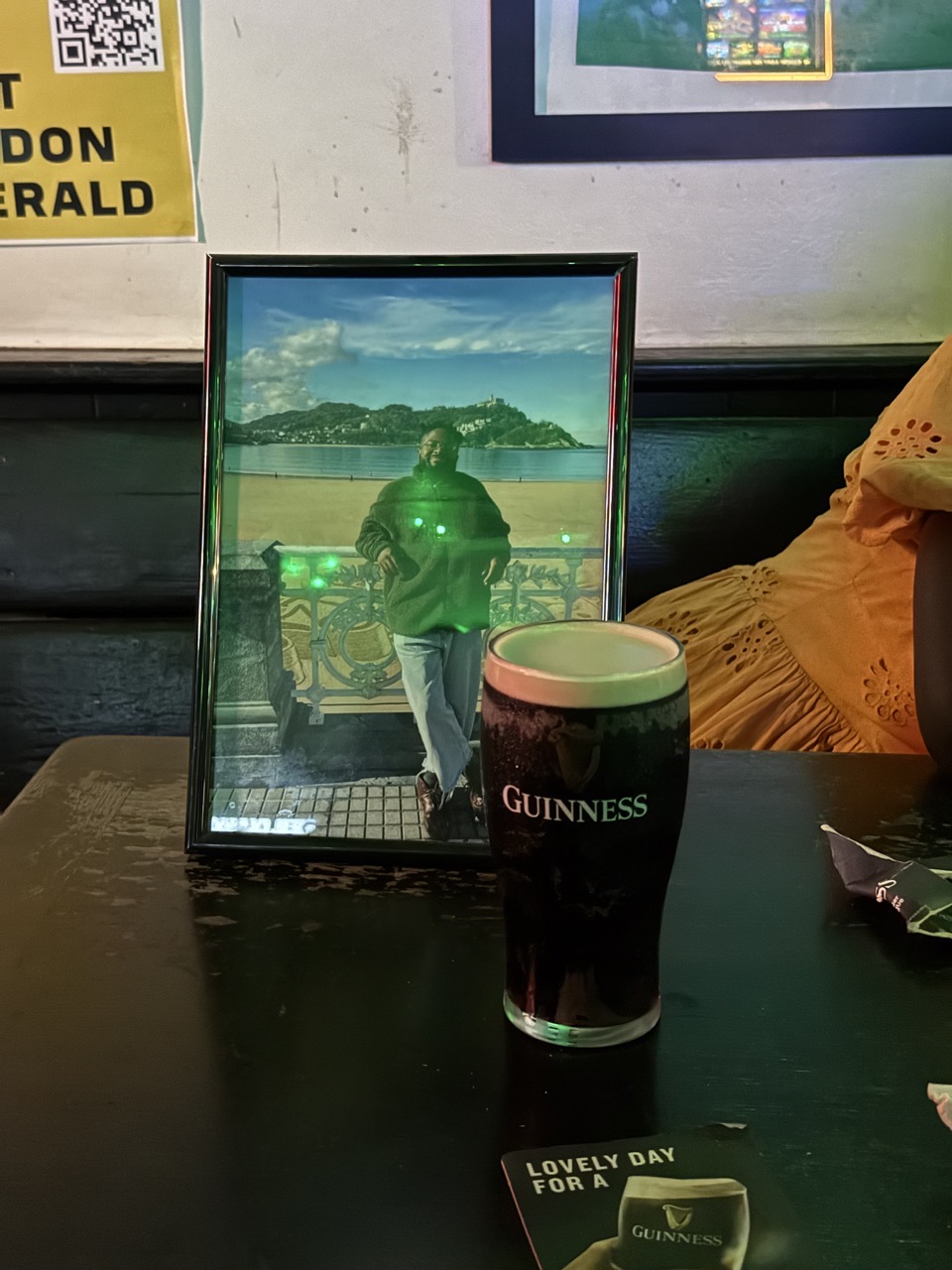 A picture of Gboyega with a pint of Guinness next to it