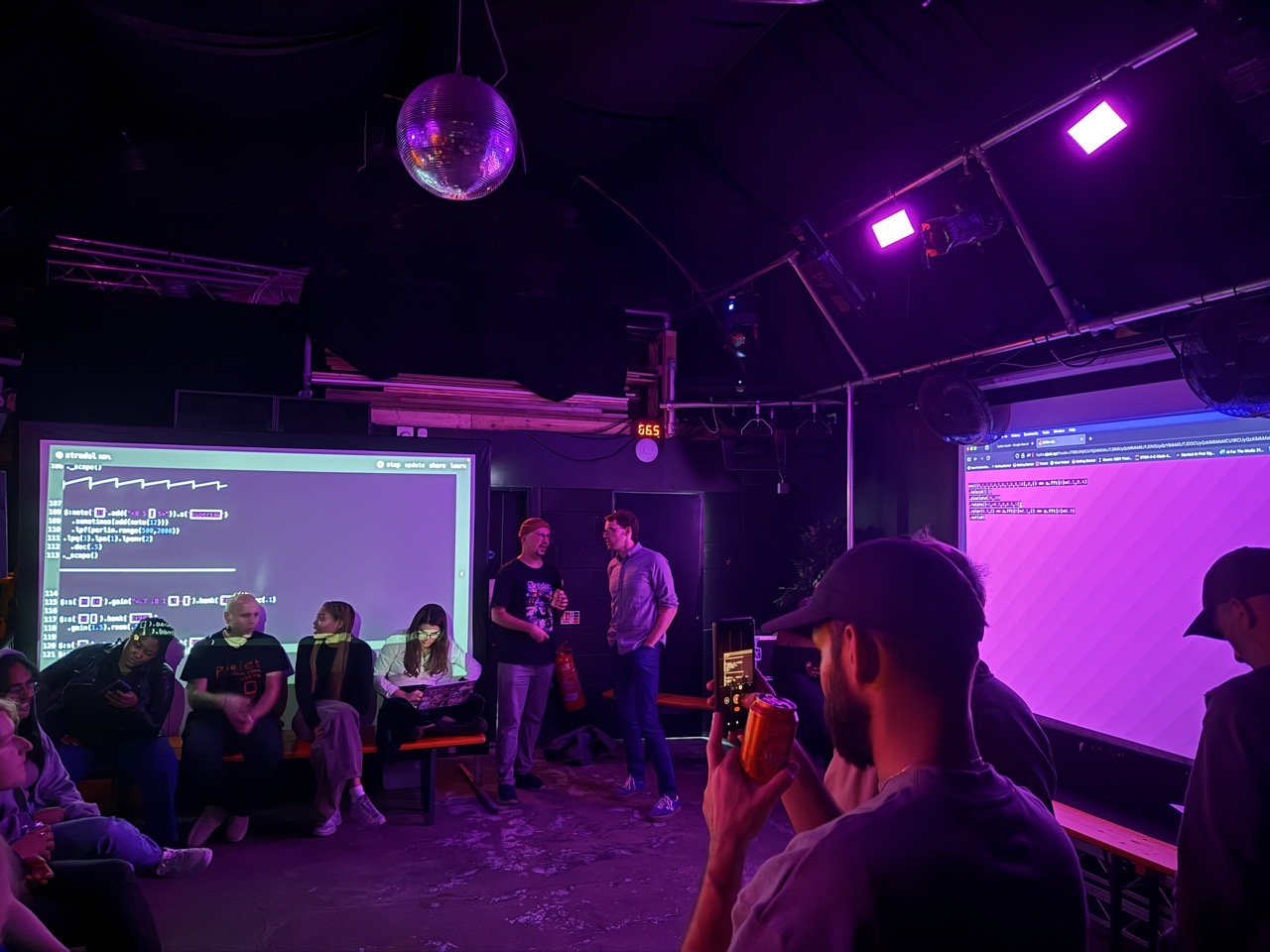 A photo of the venue at Carpet Shop showing two screens, one with Strudel and one with Hydra
