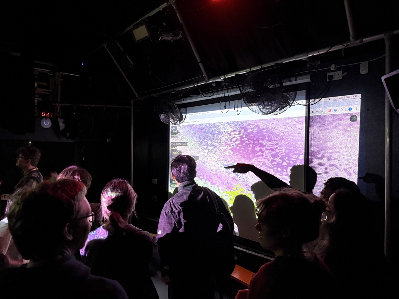 The crowd at Algorhythms in front of a visualiser screen