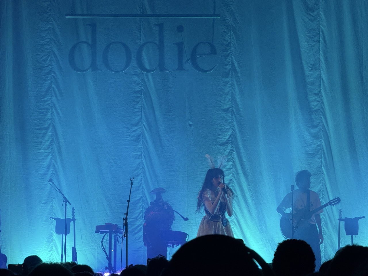 Dodie on stage with band